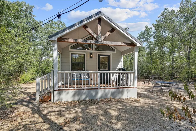 a view of a house with wooden fence