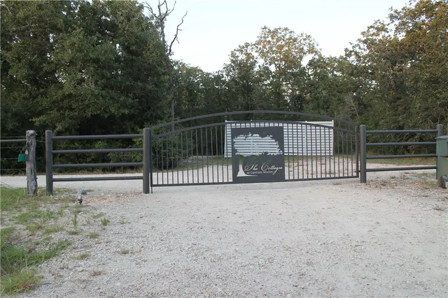 a view of a gate with wooden fence