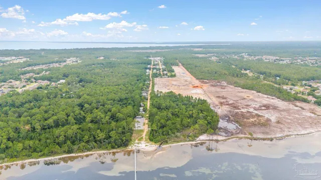 a view of a balcony with wooden floor and outdoor seating