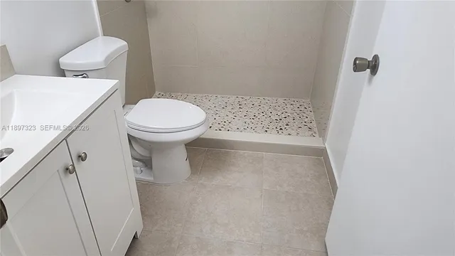 a white bath tub sitting next to a toilet