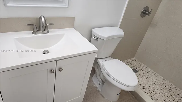 a spacious bathroom with a double vanity sink a mirror and a bathtub