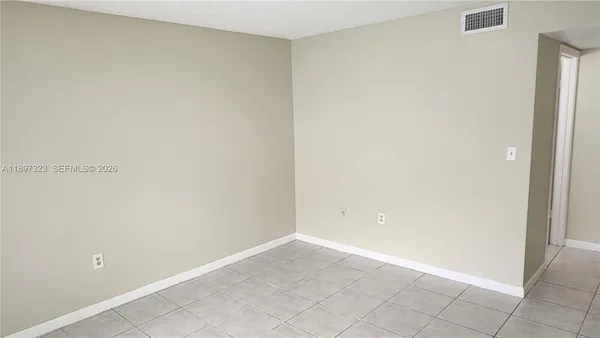an empty room with wooden floor and sliding door