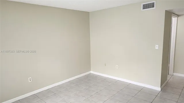 a view of a small space with wooden floor and a window