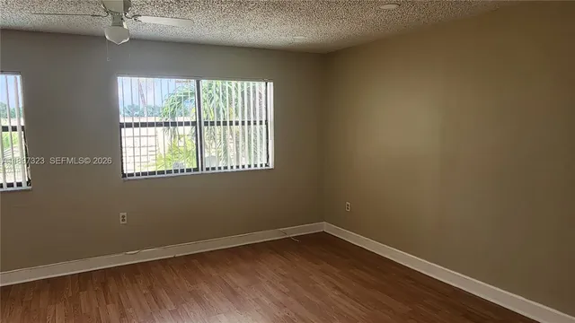 a view of a house with a small yard and a potted plant
