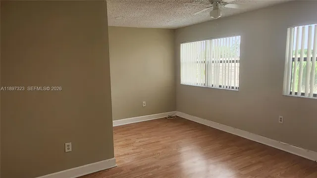 a view of a livingroom with an empty space and a window