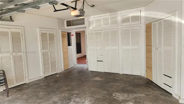 a view of a hallway with wooden shelves