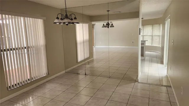 an empty room with wooden floor and cabinet