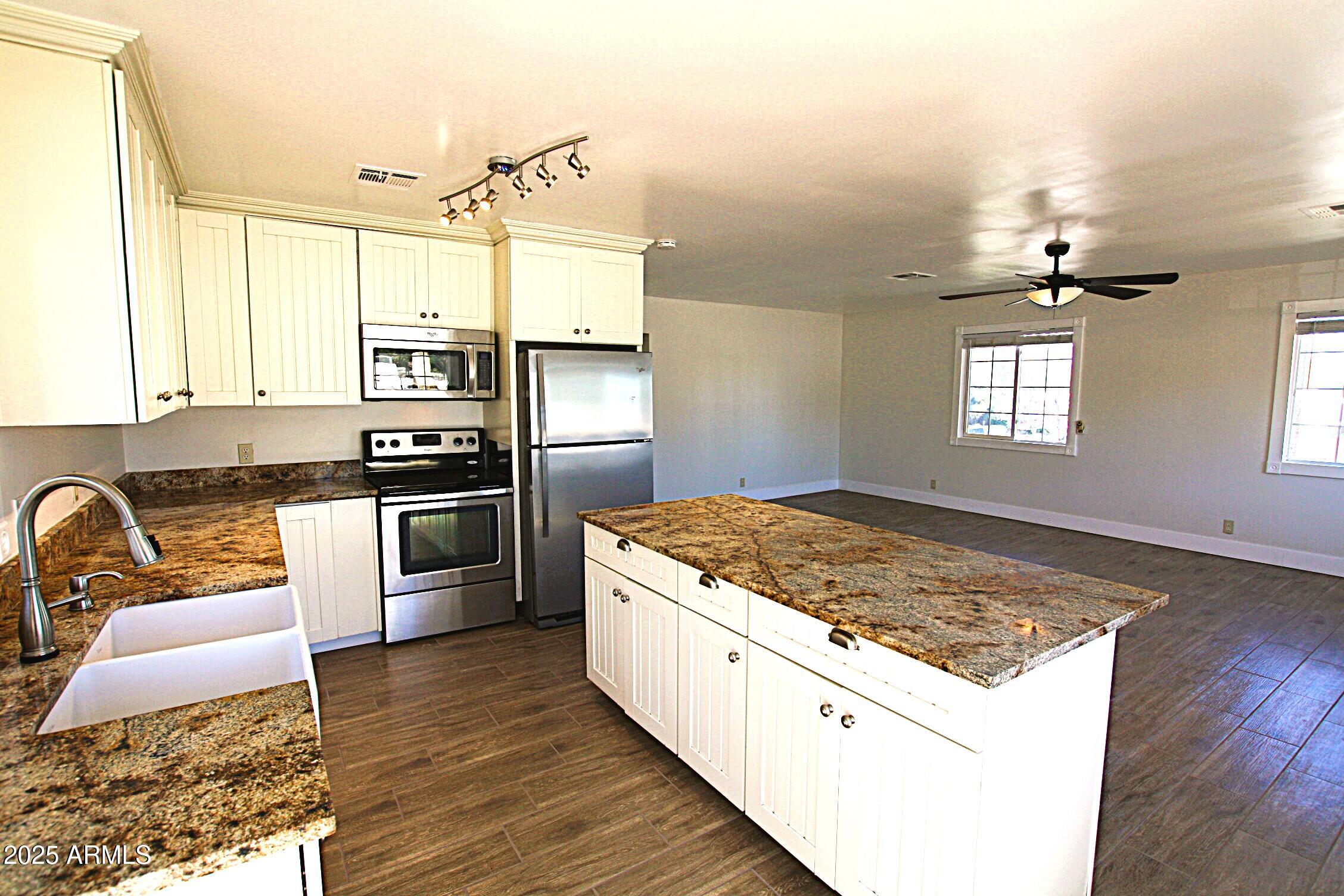 1333 East Flower Street, Unit REAR Phoenix, AZ 85014 - Photo 11 of 34 a kitchen with a stove a sink and a refrigerator