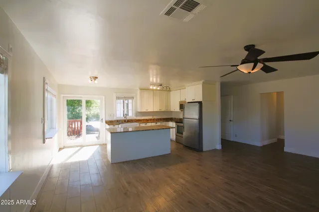 a view of a kitchen and an empty room