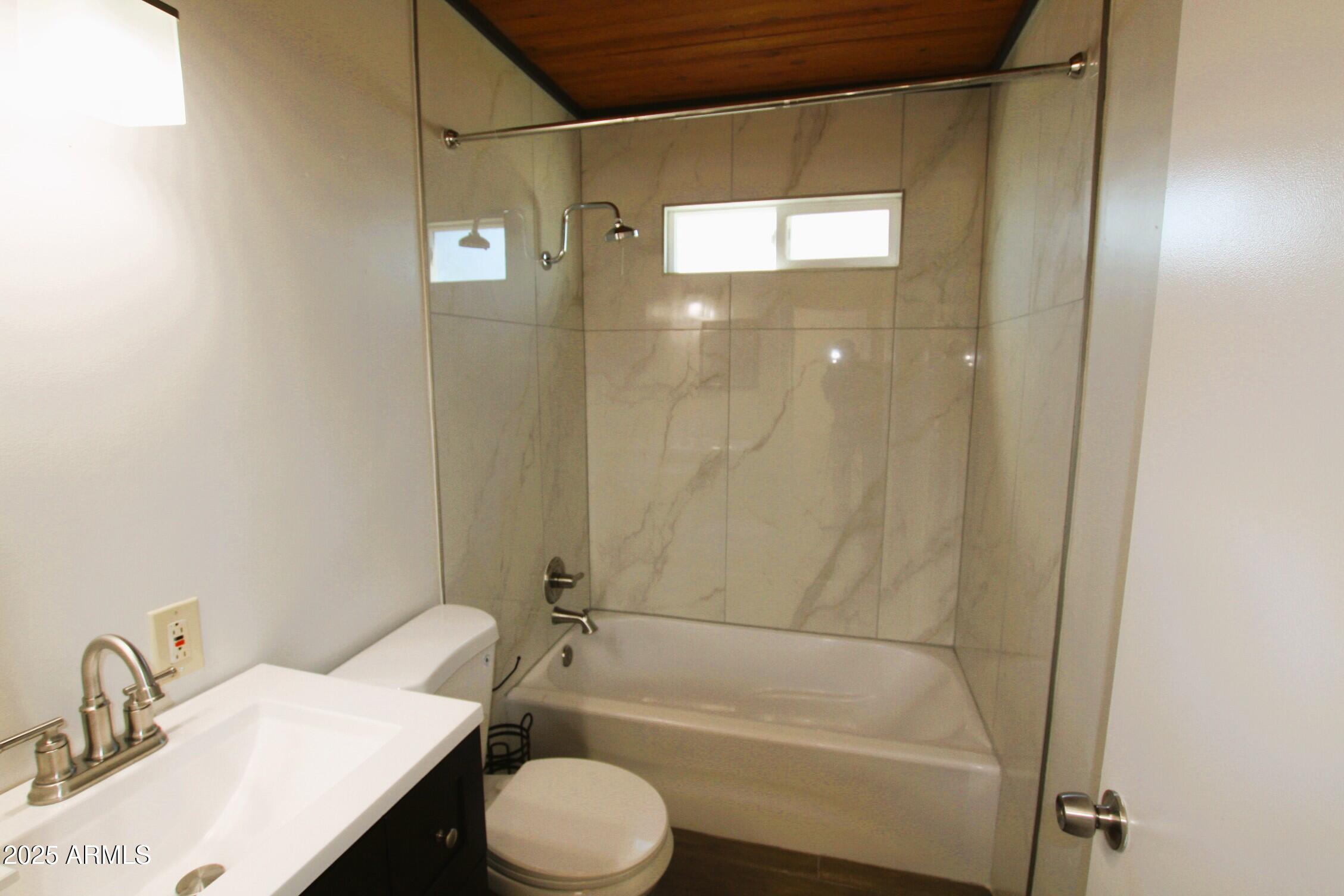 1333 East Flower Street, Unit REAR Phoenix, AZ 85014 - Photo 18 of 34 a bathroom with a sink and a mirror