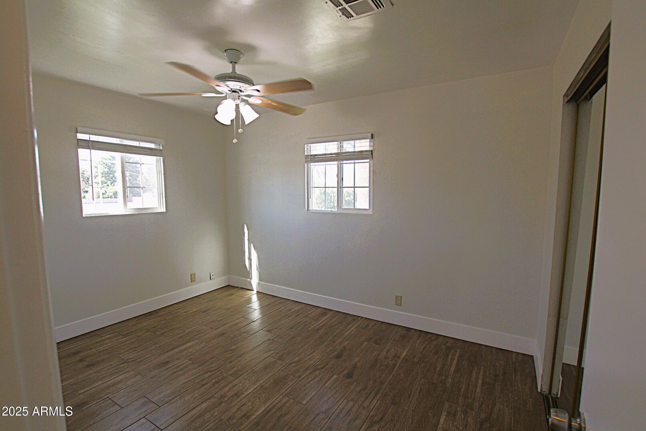 1333 East Flower Street, Unit REAR Phoenix, AZ 85014 - Photo 21 of 34 a view of empty room with wooden floor and fan