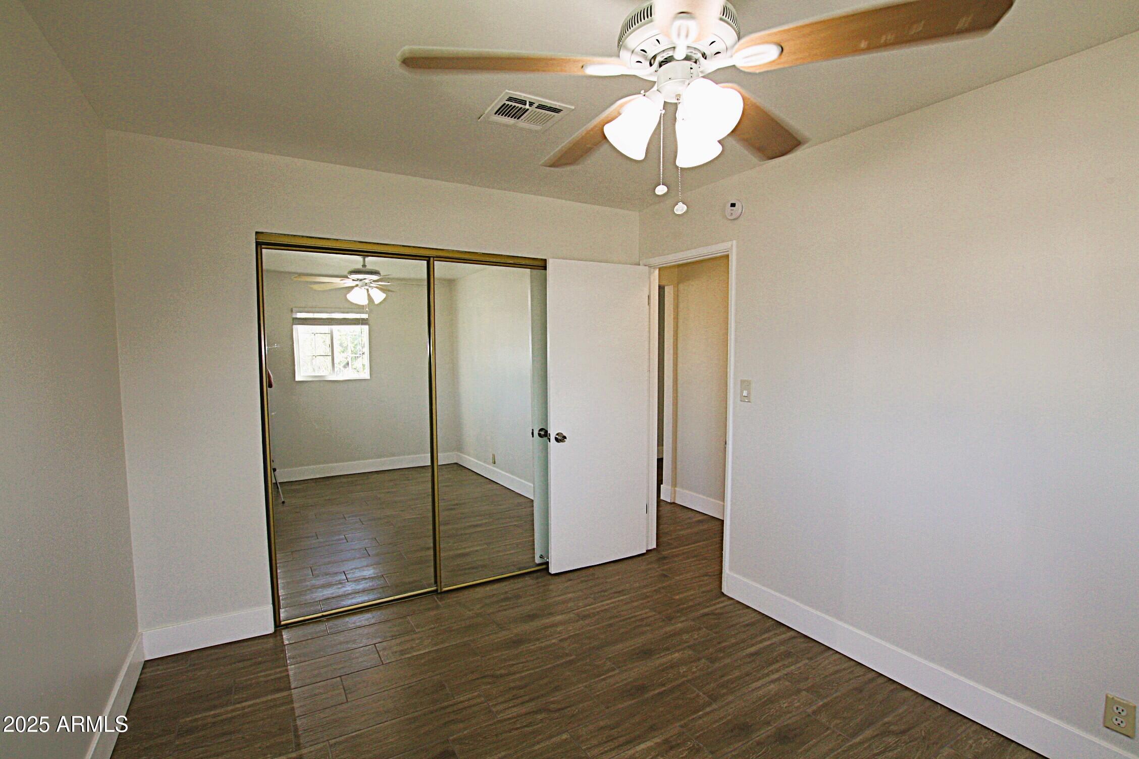 1333 East Flower Street, Unit REAR Phoenix, AZ 85014 - Photo 22 of 34 wooden floor in an empty room with a window