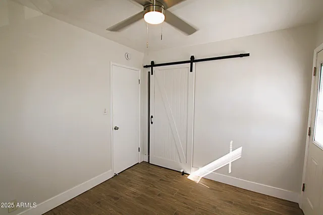 a view of a hallway with wooden floor and a sink