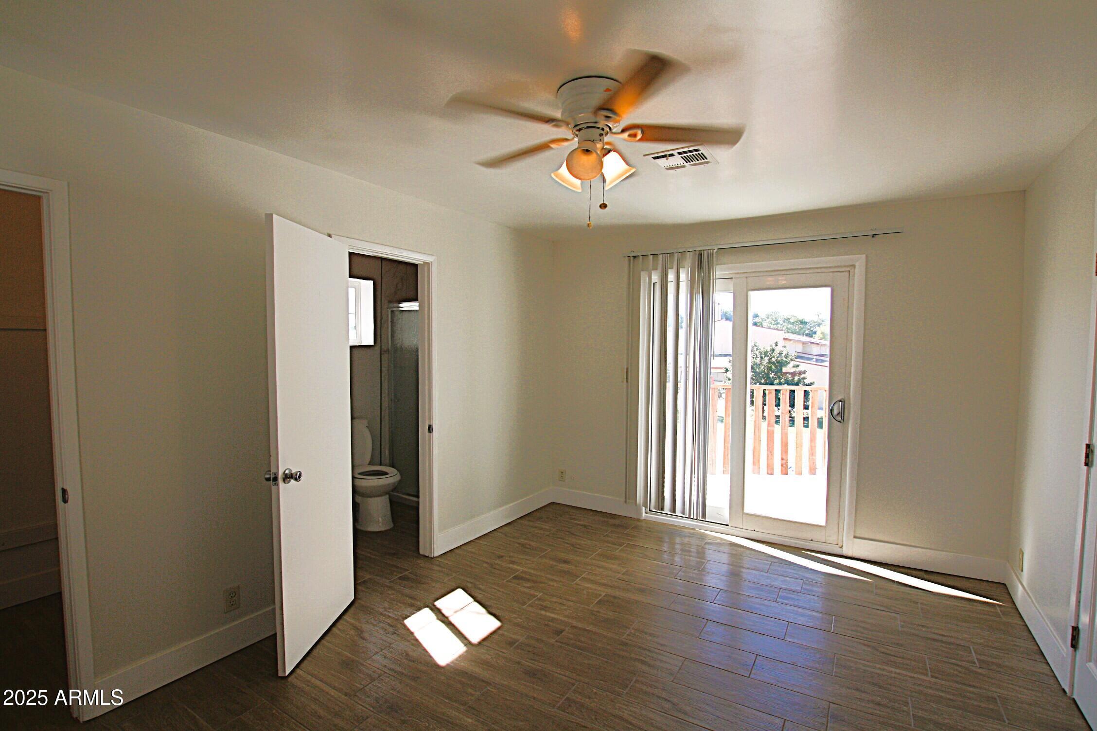 1333 East Flower Street, Unit REAR Phoenix, AZ 85014 - Photo 26 of 34 a view of an empty room with wooden floor and a window