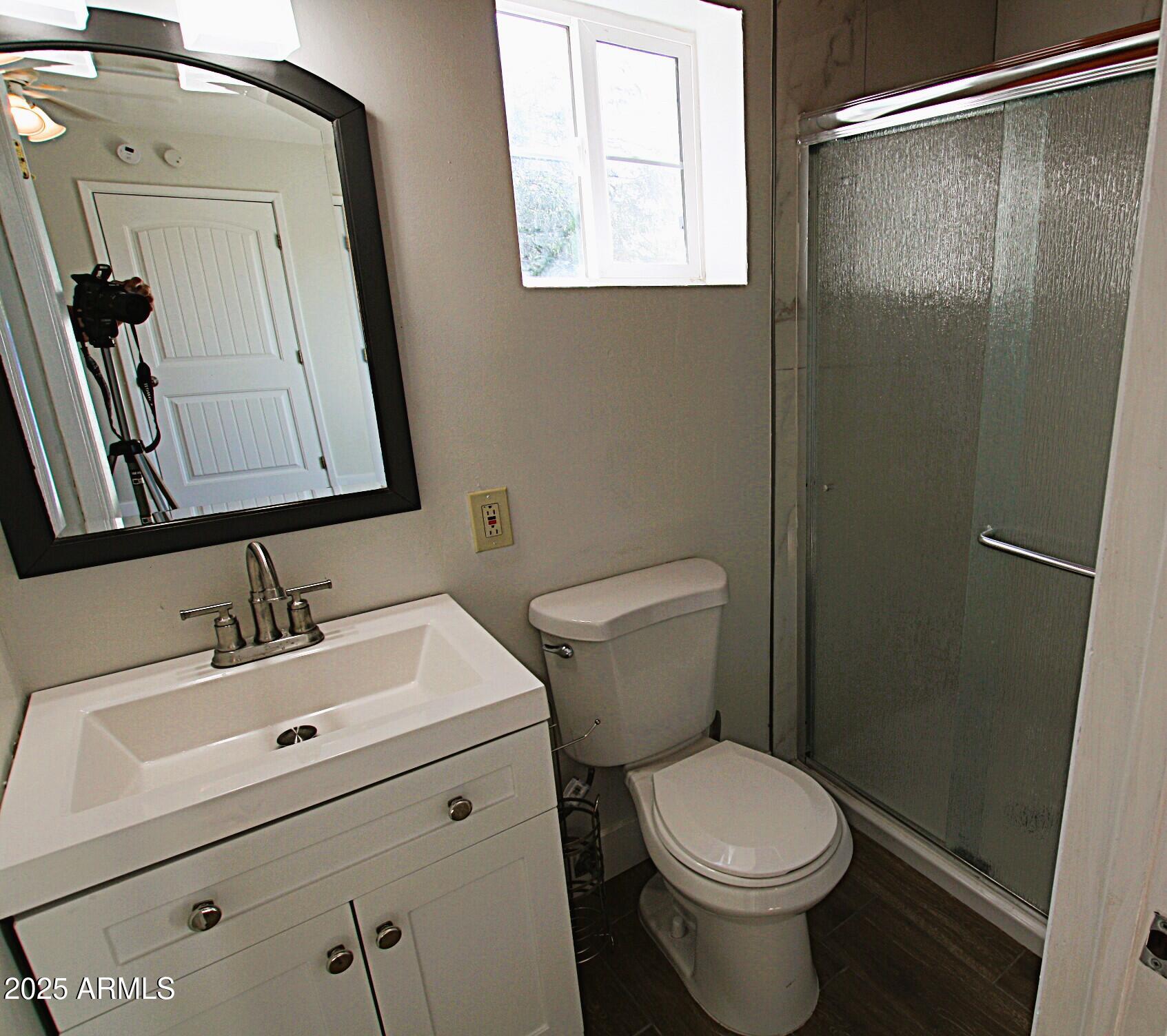 1333 East Flower Street, Unit REAR Phoenix, AZ 85014 - Photo 28 of 34 a white toilet sitting next to a bathroom sink
