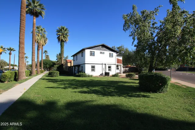 a front view of a house with a garden