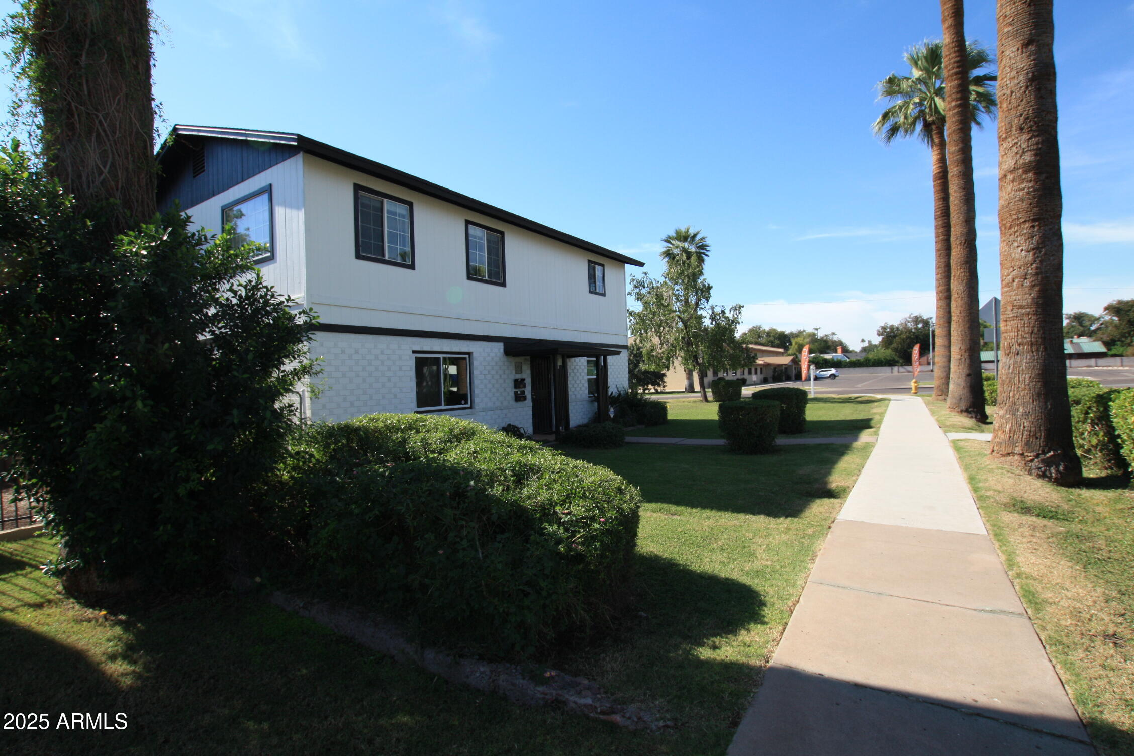 1333 East Flower Street, Unit REAR Phoenix, AZ 85014 - Photo 6 of 34 a front view of a house with a yard and potted plants