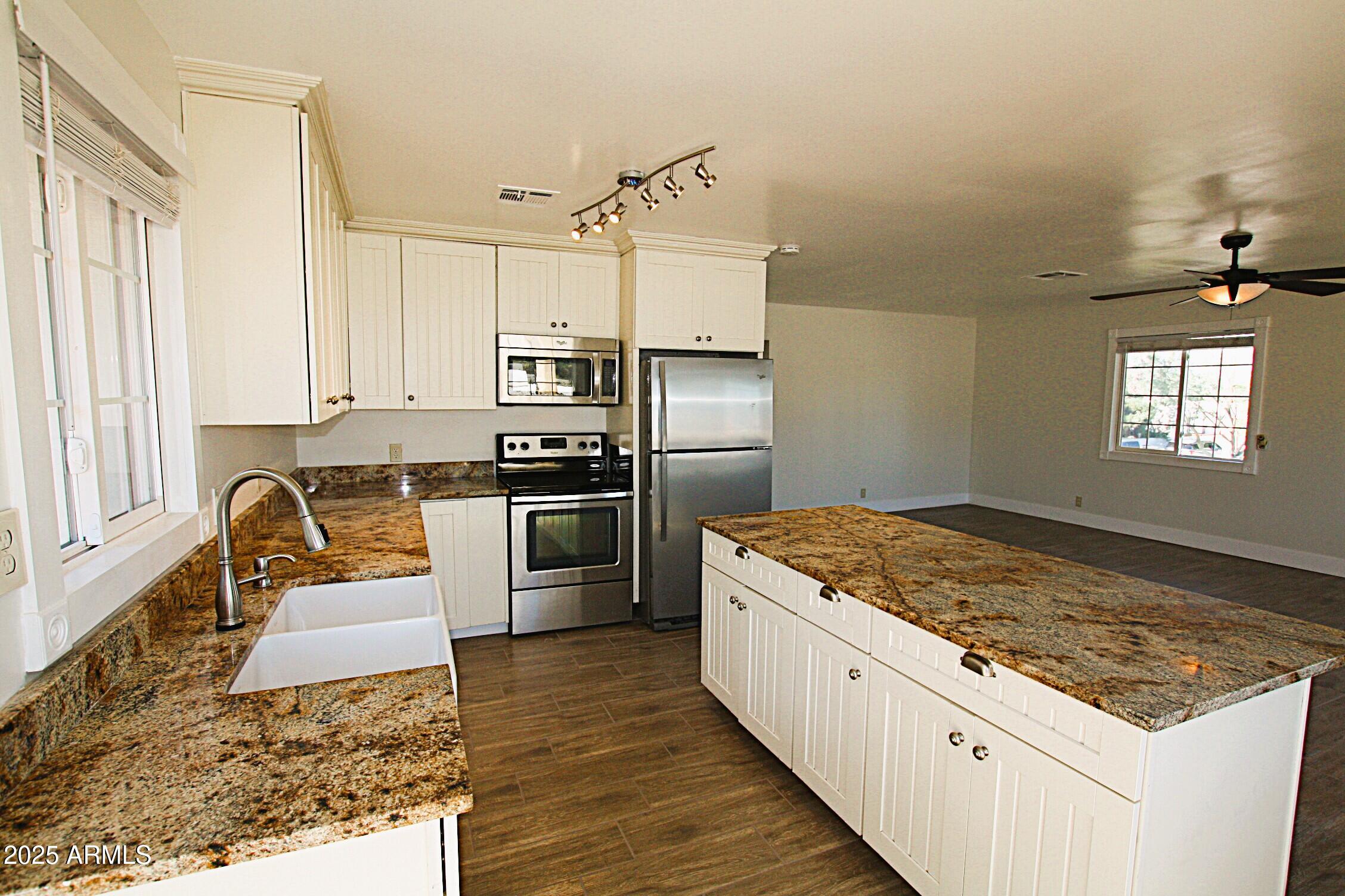 1333 East Flower Street, Unit REAR Phoenix, AZ 85014 - Photo 10 of 34 a kitchen with a stove a sink and a refrigerator