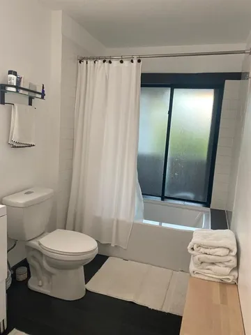 a white toilet sitting next to a bathroom sink