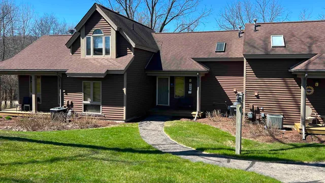 a front view of a house with garden and porch