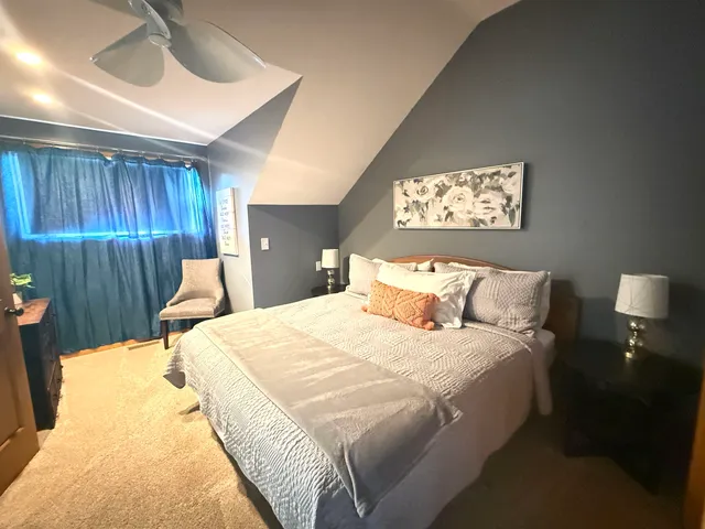 a bed room with a bed and a night stand