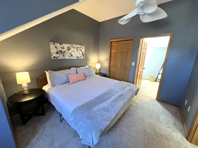 a bedroom with a bed and a lamp