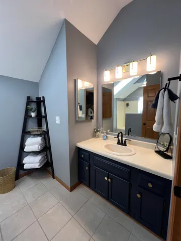 a bathroom with a double vanity sink and mirror