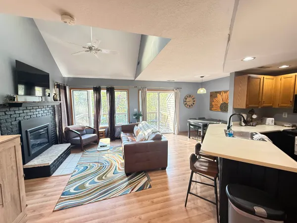 a living room with furniture fireplace and flat screen tv