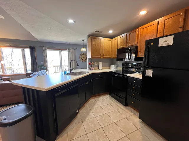 a kitchen with a sink refrigerator and cabinets