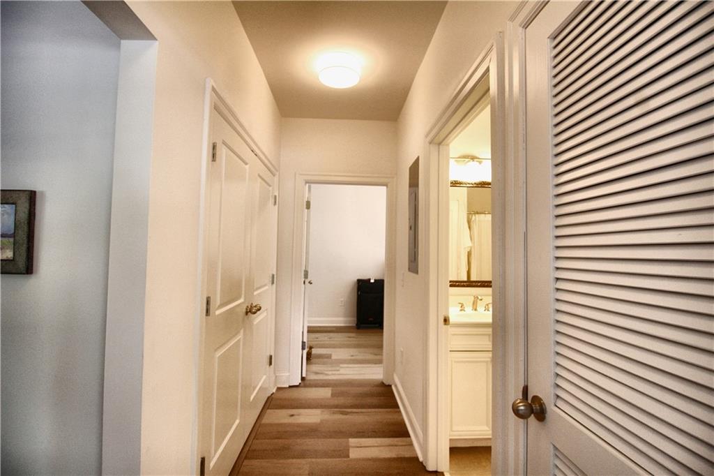 901 Abernathy Road Northeast, Unit 2110 Sandy Springs, GA 30328 - Photo 9 of 29 a view of a hallway with wooden floor and staircase