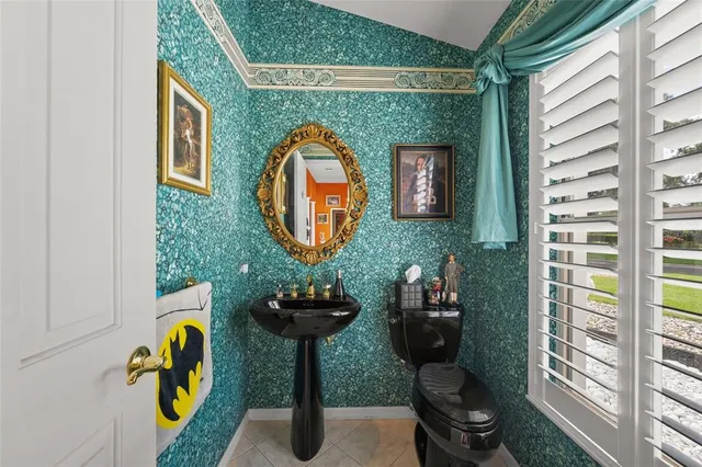 a kitchen with a stove a refrigerator and a living room view