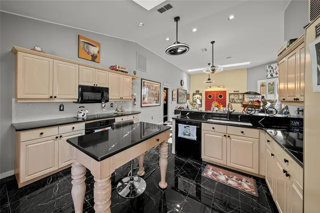 a kitchen with stainless steel appliances granite countertop a sink stove and cabinets