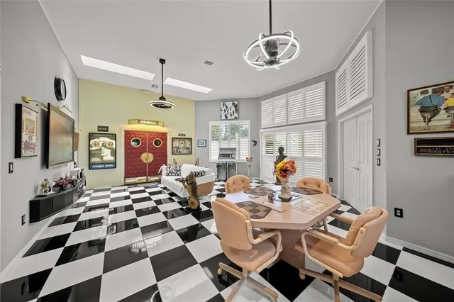 a living room with furniture pool table and a flat screen tv