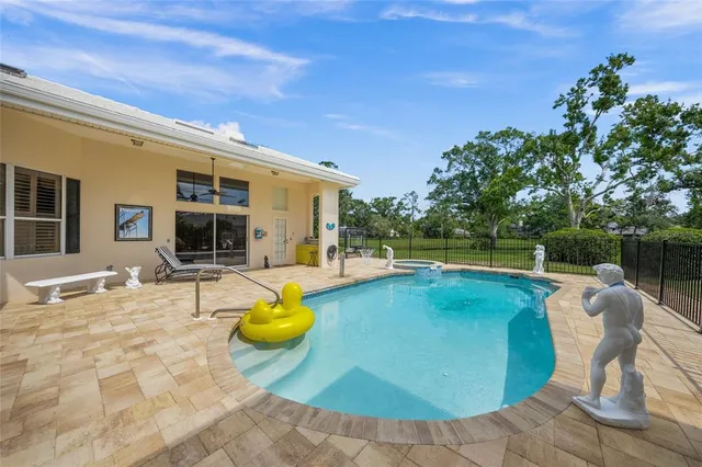 a view of a lake with a yard and large trees