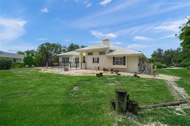an aerial view of house with yard swimming pool and outdoor seating