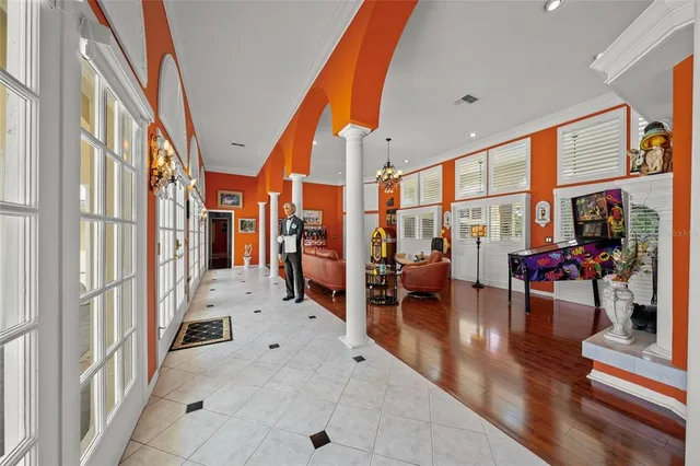 a very nice looking living room with furniture a large window and wooden floor