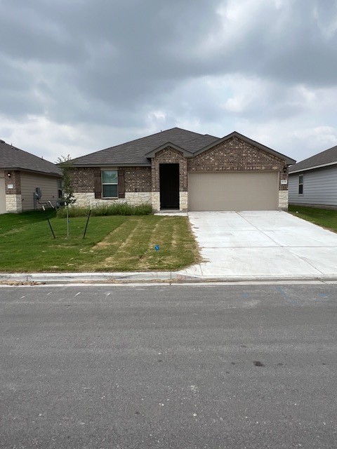 519 Wyatt Way Jarrell, TX 76537 - Photo 2 of 12 a house with a yard and a car parked in it