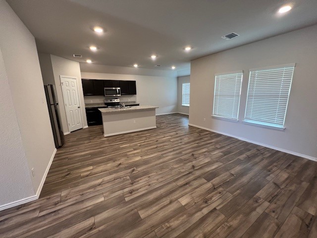 519 Wyatt Way Jarrell, TX 76537 - Photo 4 of 12 a view of kitchen with kitchen island wooden floor and stainless steel appliances