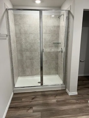 a bathroom with a glass shower door