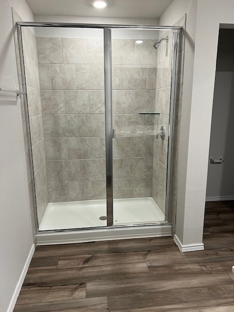 519 Wyatt Way Jarrell, TX 76537 - Photo 7 of 12 a bathroom with a glass shower door