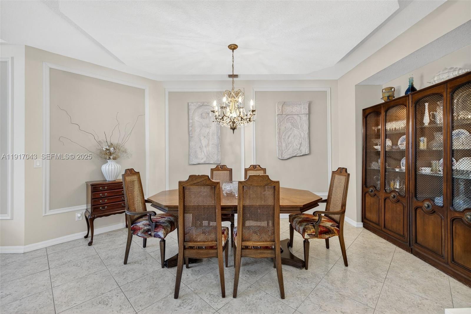 4123 West Lake Estates Drive Davie, FL 33328 - Photo 11 of 56 a view of a dining room with furniture and chandelier
