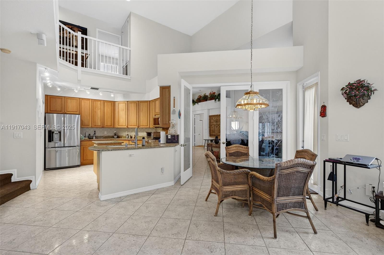 4123 West Lake Estates Drive Davie, FL 33328 - Photo 14 of 56 a view of a dining room with furniture and chandelier
