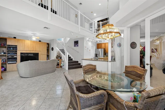 a kitchen with stainless steel appliances granite countertop a stove a sink a refrigerator and island