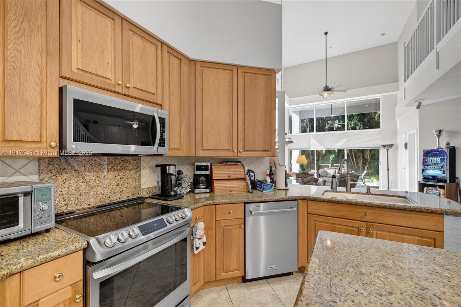 4123 West Lake Estates Drive Davie, FL 33328 - Photo 19 of 56 a kitchen with stainless steel appliances a stove sink and cabinets