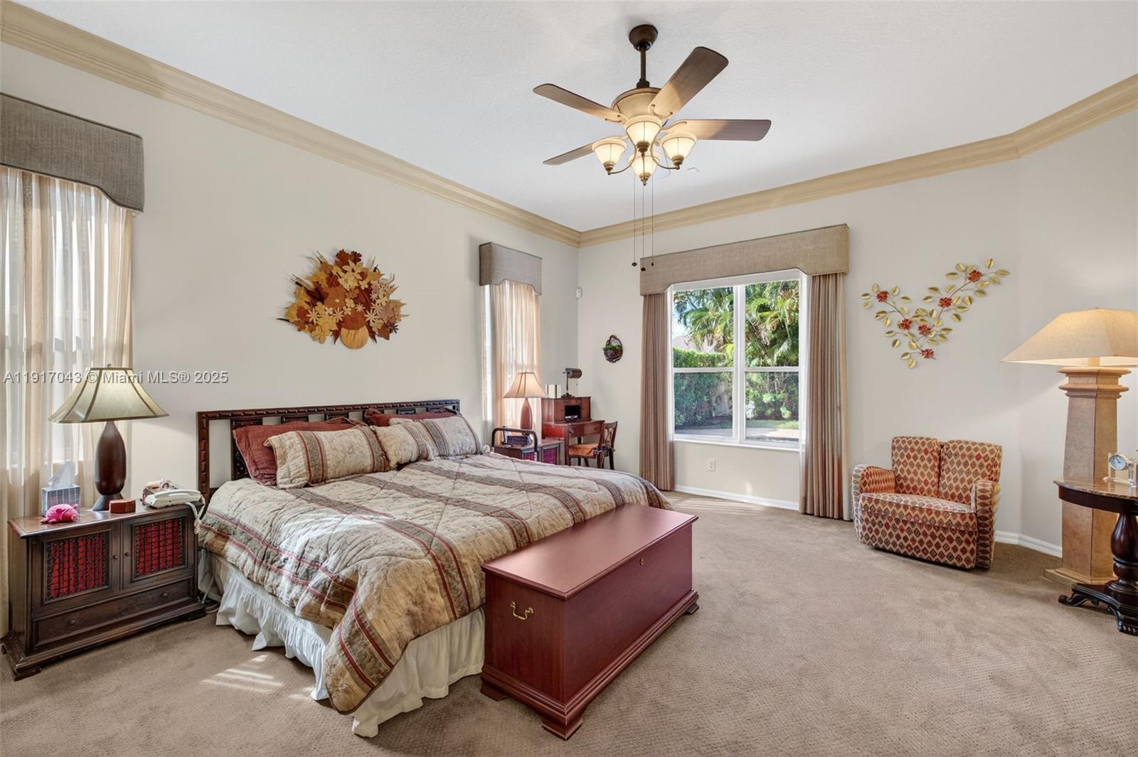 4123 West Lake Estates Drive Davie, FL 33328 - Photo 22 of 56 a spacious bedroom with a bed a couch and a chandelier