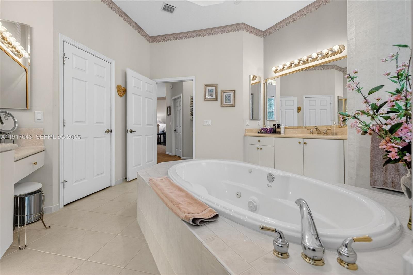 4123 West Lake Estates Drive Davie, FL 33328 - Photo 27 of 56 a spacious bathroom with a tub sink and mirror
