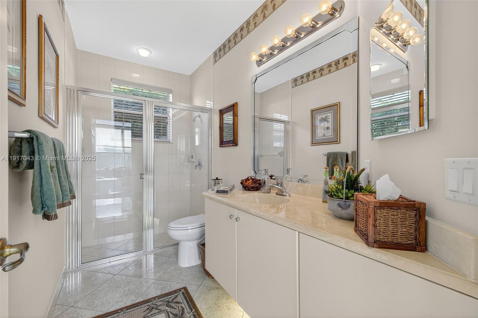 4123 West Lake Estates Drive Davie, FL 33328 - Photo 28 of 56 a spacious bathroom with a granite countertop sink a toilet a mirror and shower