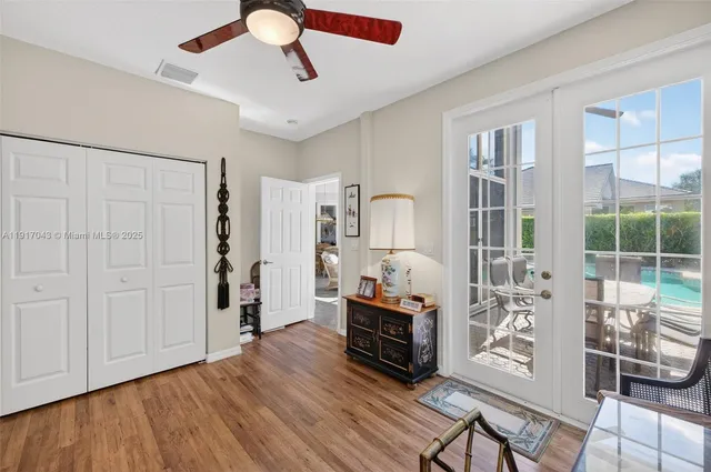 a living room with furniture a flat screen tv and a window