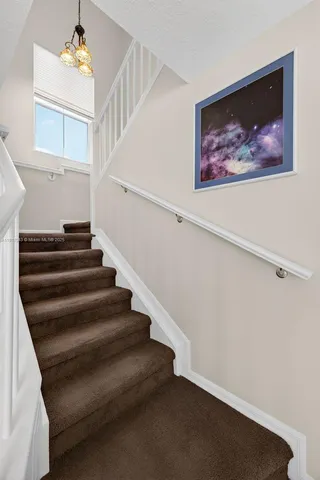 a workspace with furniture and floor to ceiling window