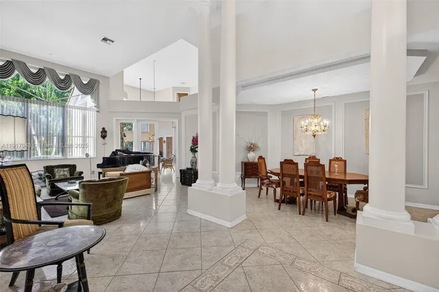a living room with furniture and a chandelier